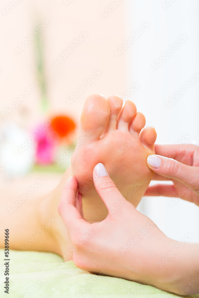 Woman in nail salon receiving foot massage Woman in nail salon receiving foot massage