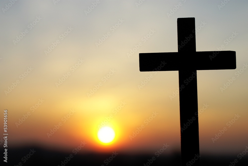 Silhouette of wooden cross on sky background
