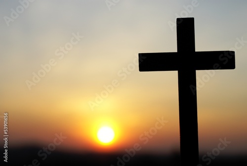 Silhouette of wooden cross on sky background