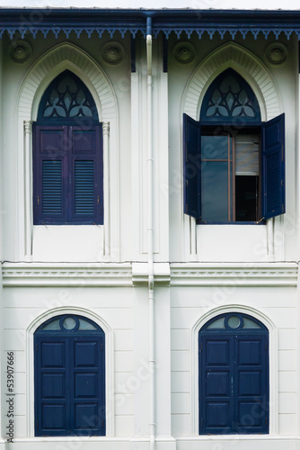 One opened blue window on a Thai vintage building architecture