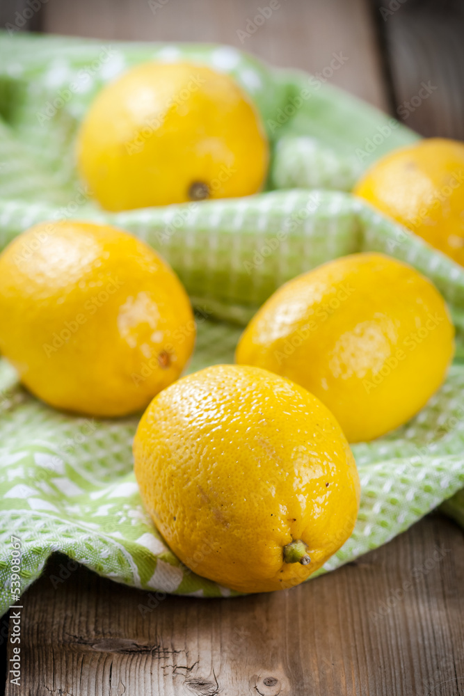 Fresh lemons on wooden table