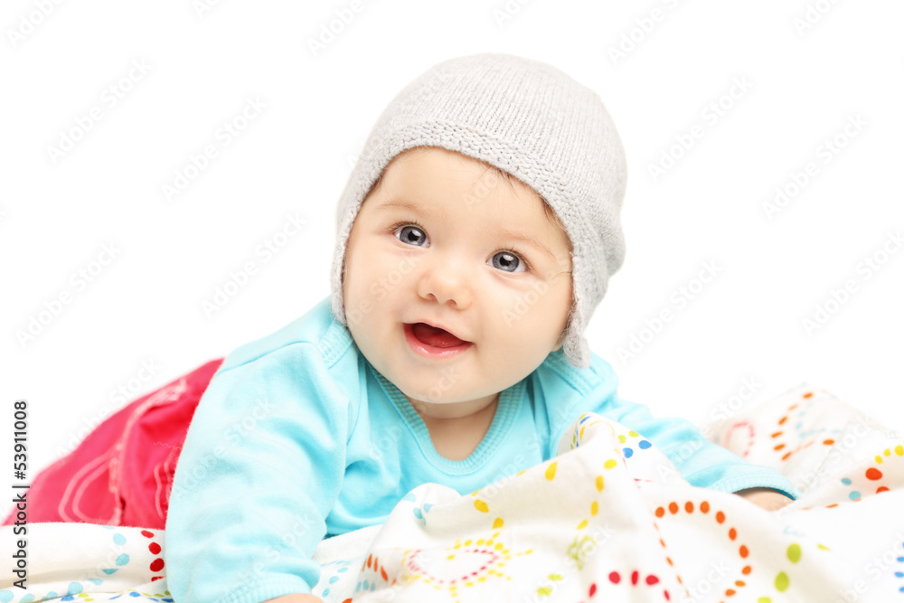 Baby girl with hat lying down and smiling Baby girl with hat lying down and smiling