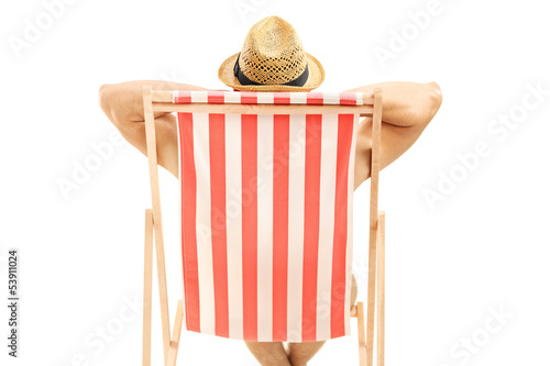 Man with hat sitting on a beach chair