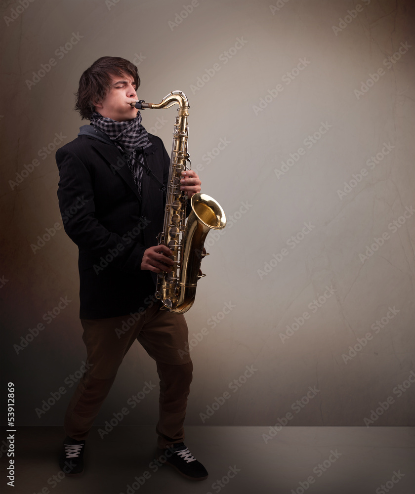 Fototapeta premium Young musician playing on saxophone
