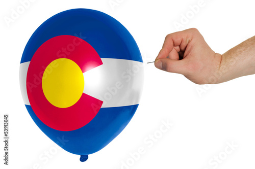 Bursting balloon colored in  flag of american state of colorado photo