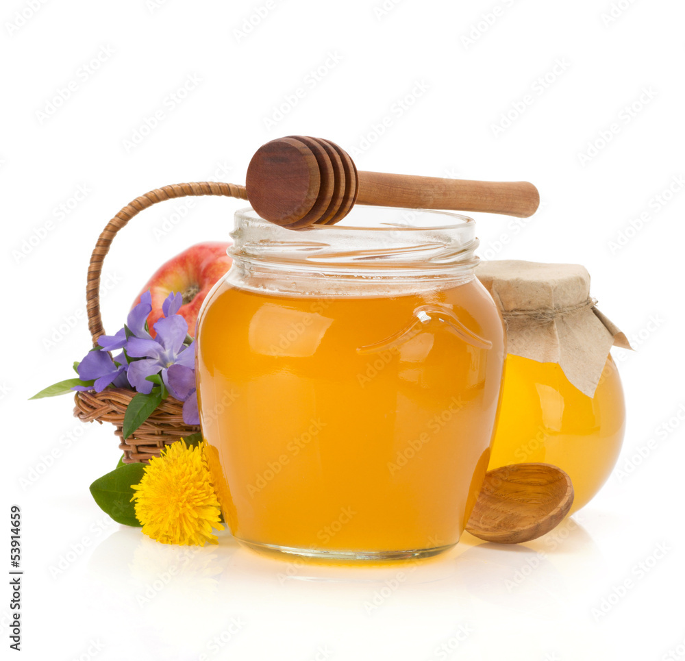 glass jar full of honey and stick glass jar full of honey and stick