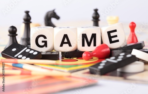 Detail of board games, pawns, chessmen, dominoes, mikado sticks. photo