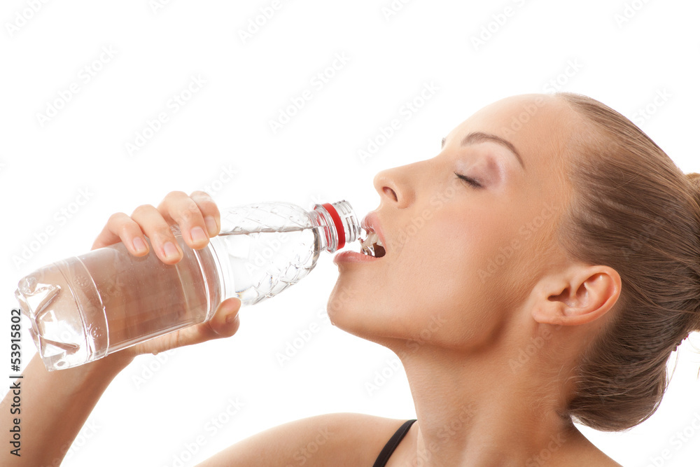 Woman in fitness wear drinking water, isolated on white Woman in fitness wear drinking water, isolated on white