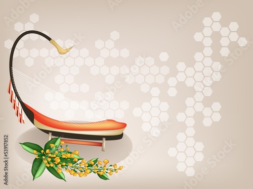 A Musical Saung and Yellow Padauk Flower on Brown Background photo