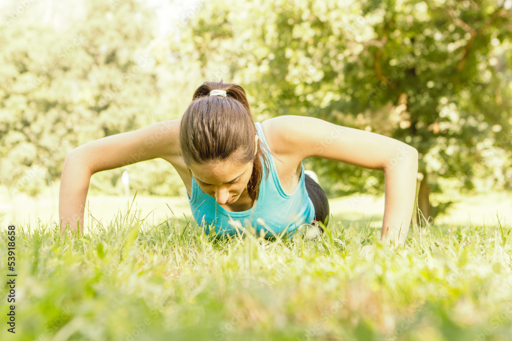 Fitness woman doing push-ups Fitness woman doing push-ups