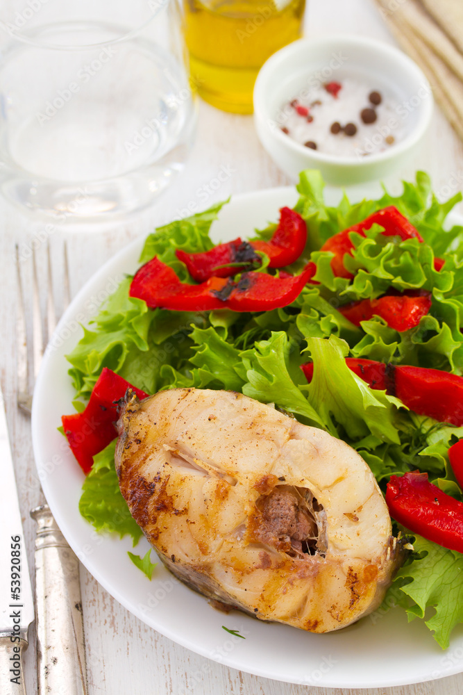 fish with salad on plate and olive oil fish with salad on plate and olive oil