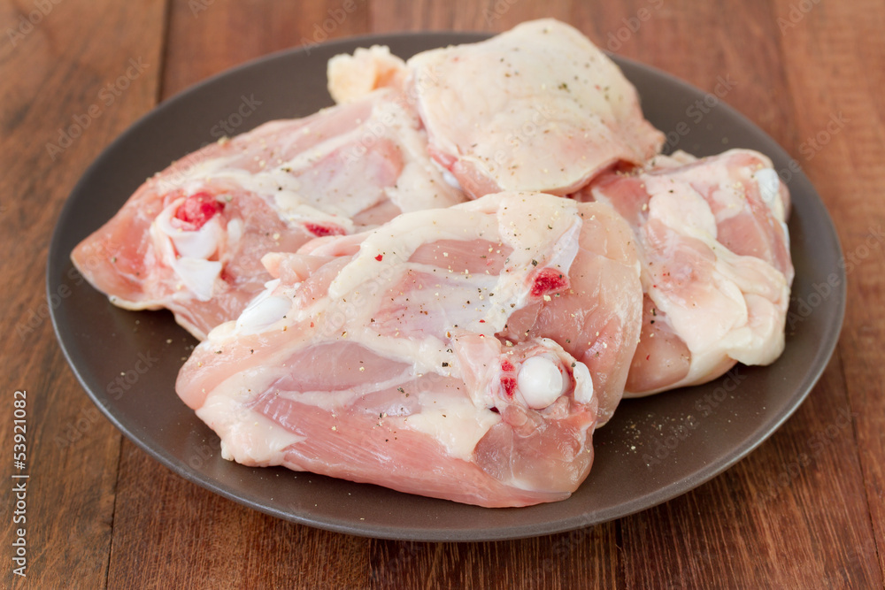 raw chicken on brown plate