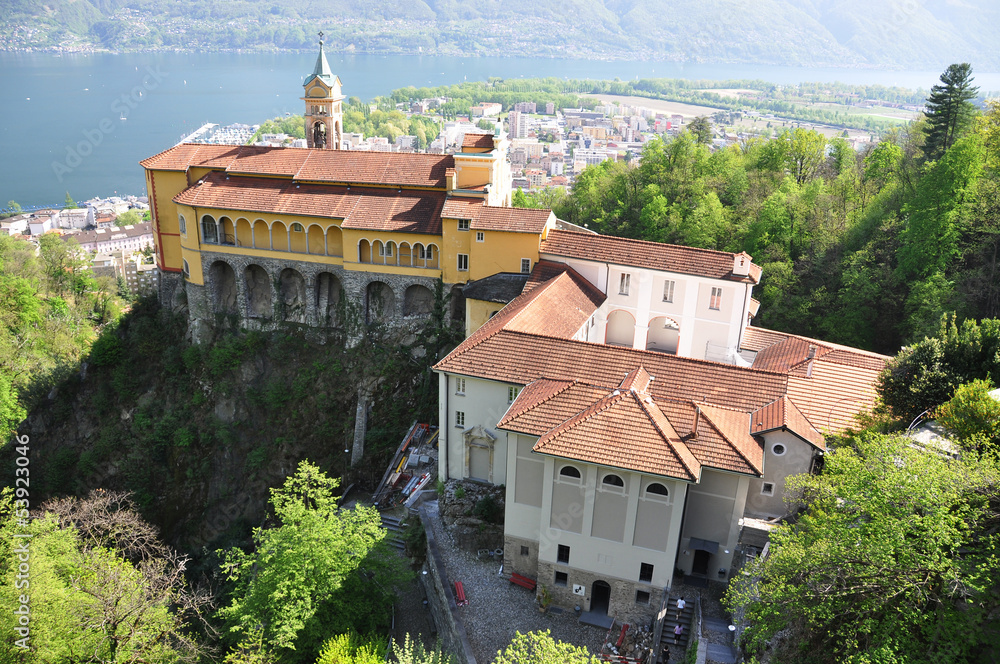 Obraz premium Madonna del Sasso, medieval monastery on the rock overlook lake