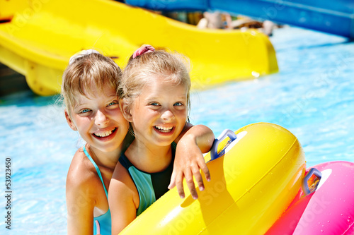 Child on water slide at aquapark. photo