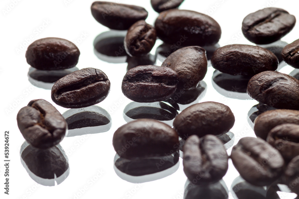 Coffee beans on a mirroring surface Coffee beans on a mirroring surface