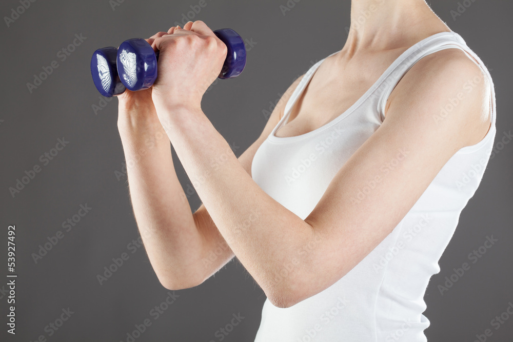 Woman doing exercises with dumbbells Woman doing exercises with dumbbells