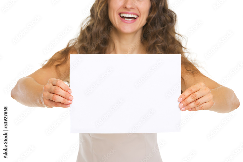 Closeup on smiling young woman showing blank paper Closeup on smiling young woman showing blank paper