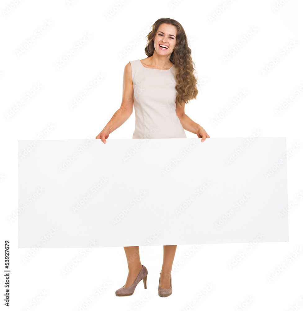Full length portrait of happy woman showing blank billboard Full length portrait of happy woman showing blank billboard