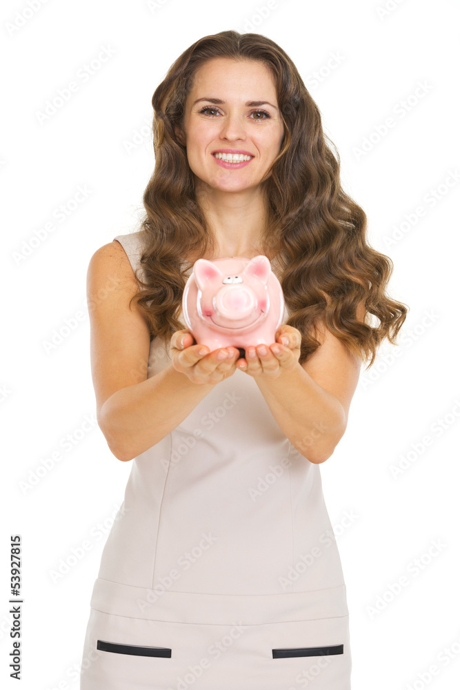 Young woman showing piggy bank Young woman showing piggy bank