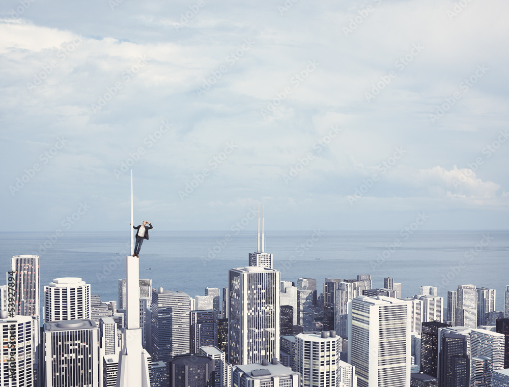 Obraz premium man on the top of skyscraper looking at the city