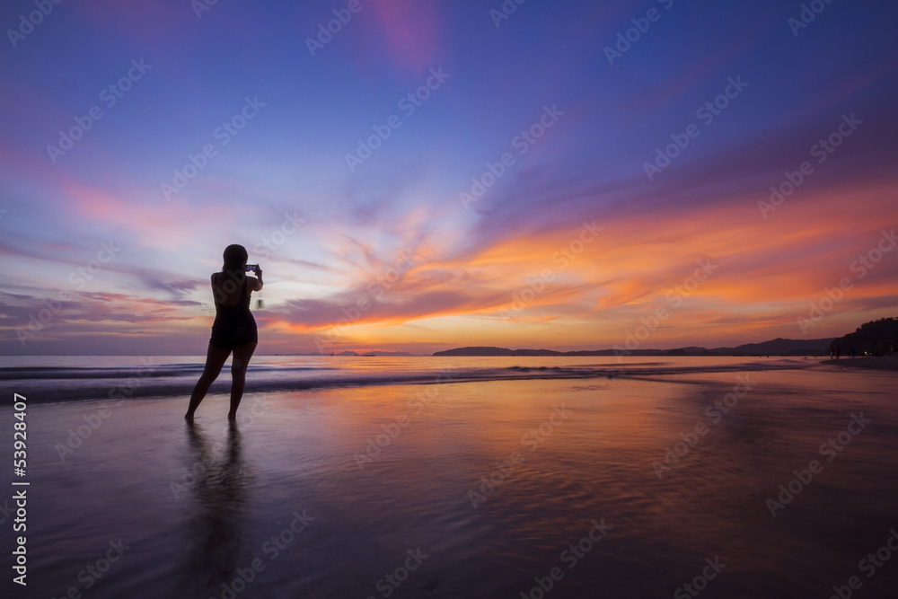 Silhouette girl in amazing sunset.
