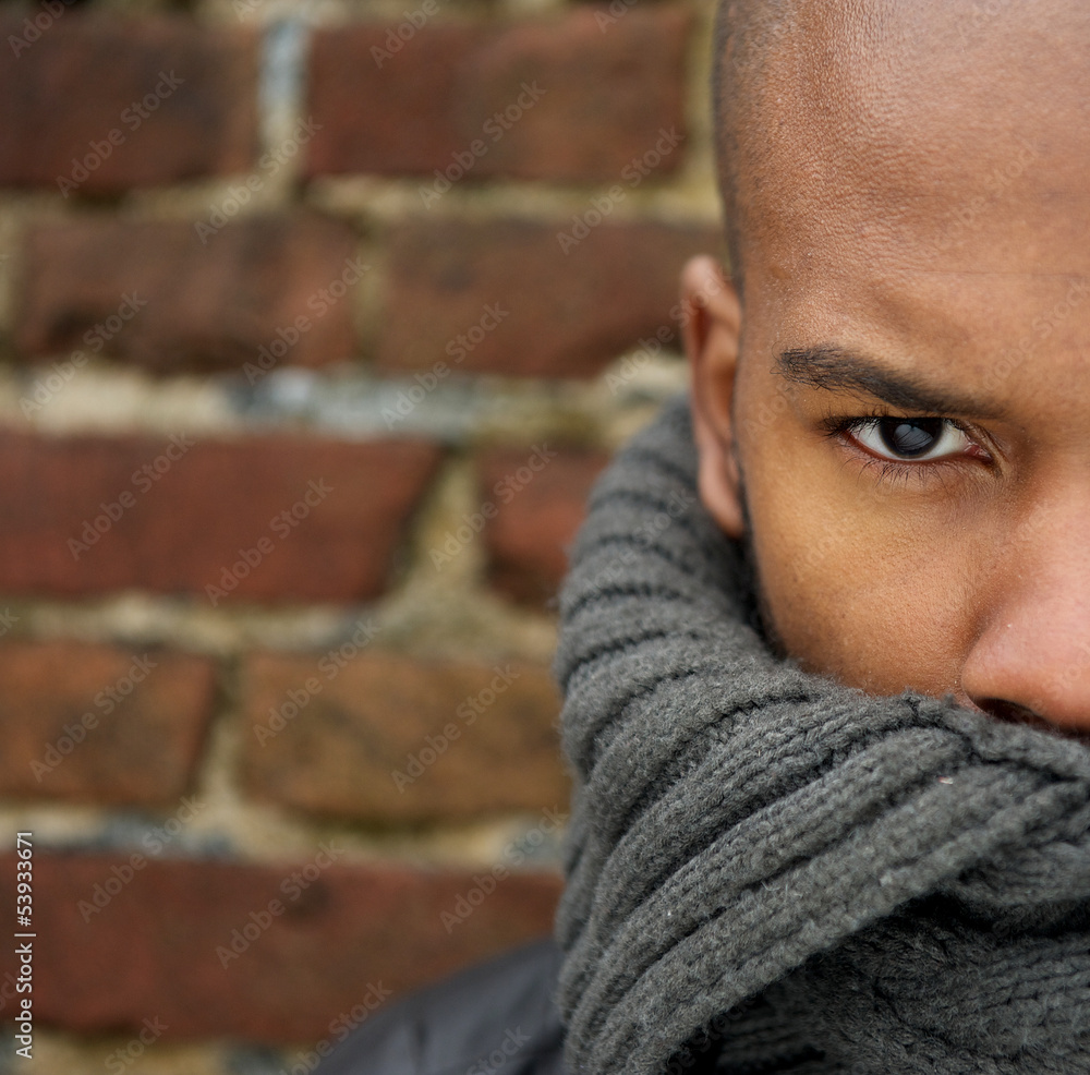 Attractive male fashion model with scarf covering face Attractive male fashion model with scarf covering face