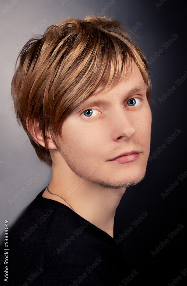 stylish handsome young man posing in studio, looking at camera. stylish handsome young man posing in studio, looking at camera.