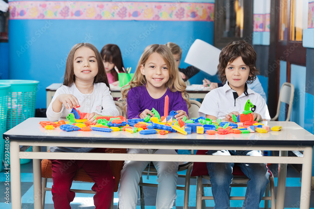 Fototapeta premium Children Playing With Construction Blocks In Kindergarten