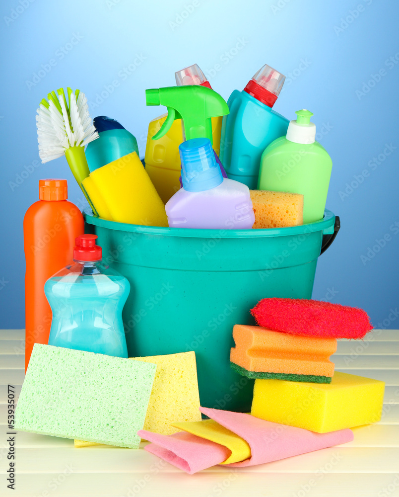Cleaning items in bucket on color background Cleaning items in bucket on color background