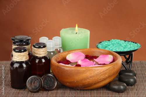 Spa composition with aroma oils on brown background