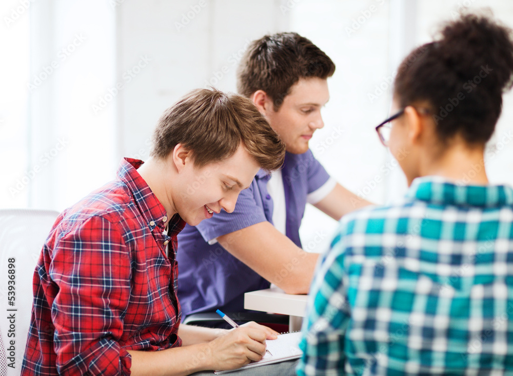 student with notebook studying at school