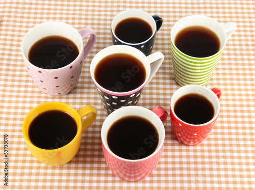 Many cups of coffee on checkered napkin