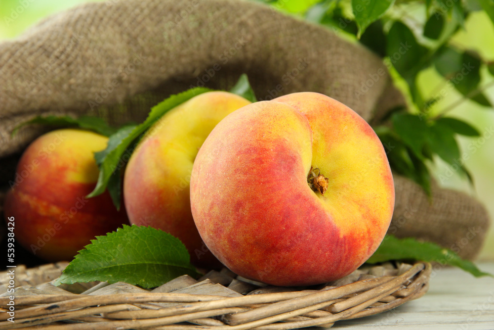 Ripe sweet peaches on wooden table in garden, close up Ripe sweet peaches on wooden table in garden, close up