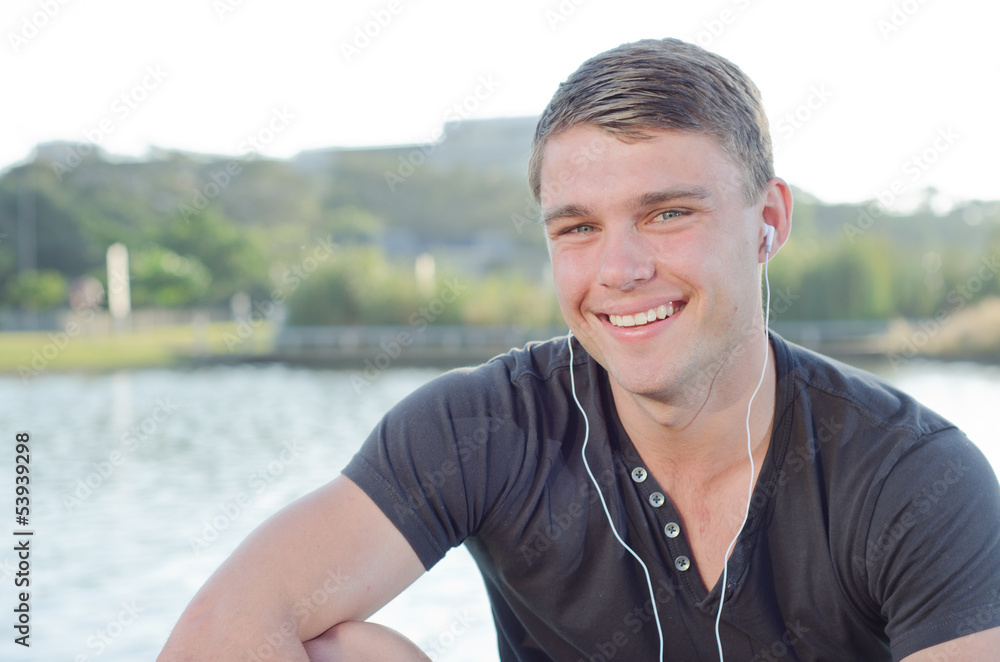 Fototapeta premium Handome teen smiling with earphones on