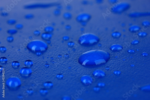 Water drops on blue plastic background