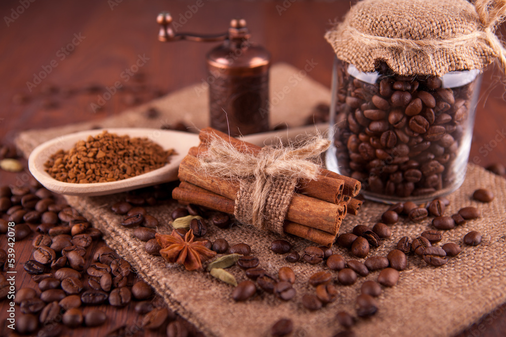 coffee beans and cinnamon sticks on a wooden board