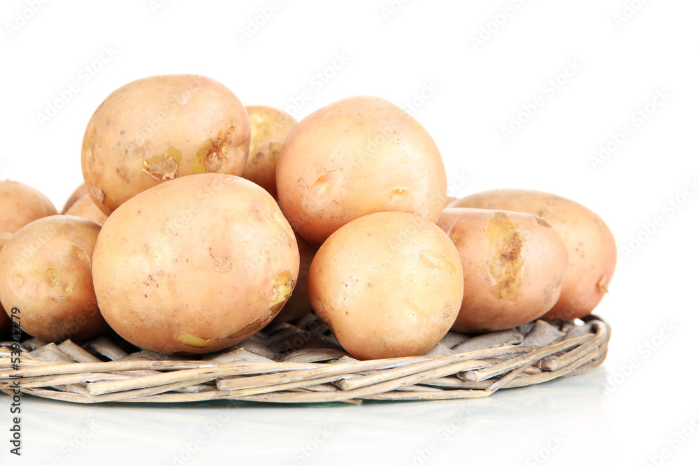 Potato on wicker wooden tray isolated on white Potato on wicker wooden tray isolated on white