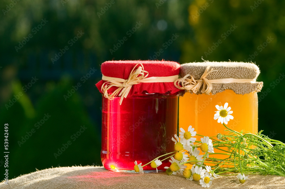 Jam and honey on green background