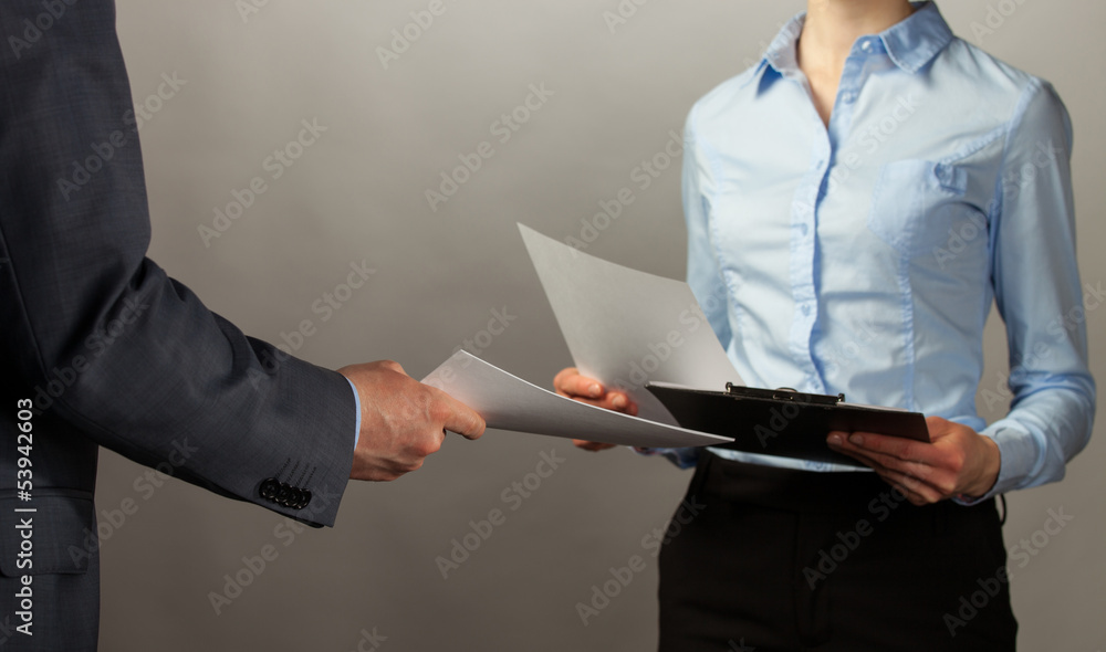 Businessman and businesswoman interchange of documents Businessman and businesswoman interchange of documents