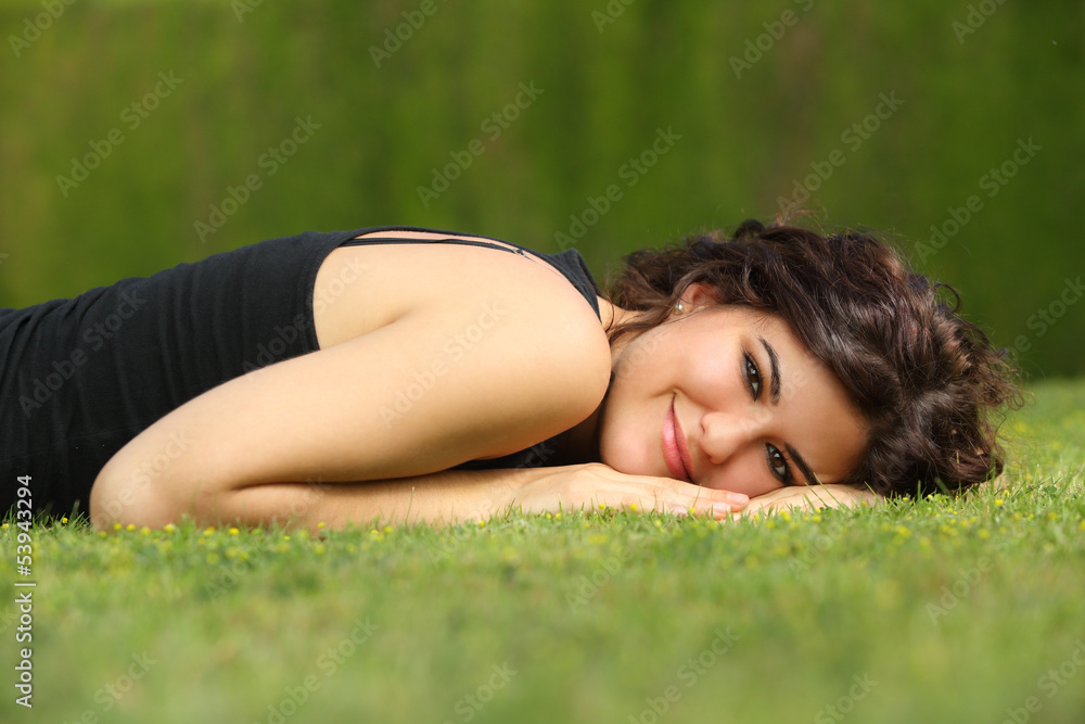 Beautiful woman lying on the grass relaxed Beautiful woman lying on the grass relaxed