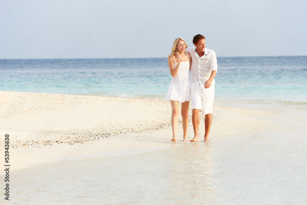 Romantic Couple Walking On Beautiful Tropical Beach