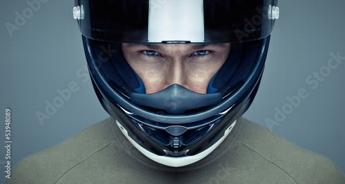Handsome man in helmet on blue background photo