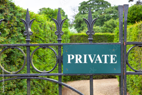 Private sign on a gate leading to a garden.