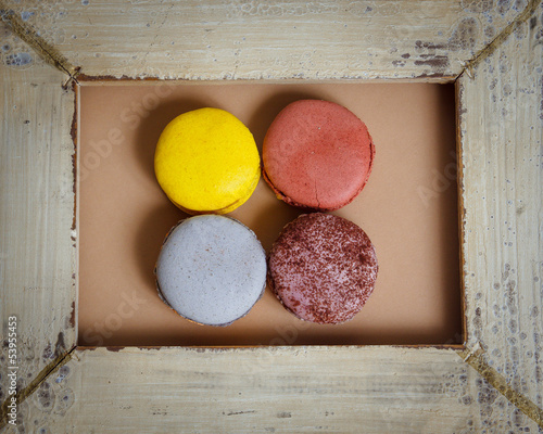 Delicious macaroons on wood frame