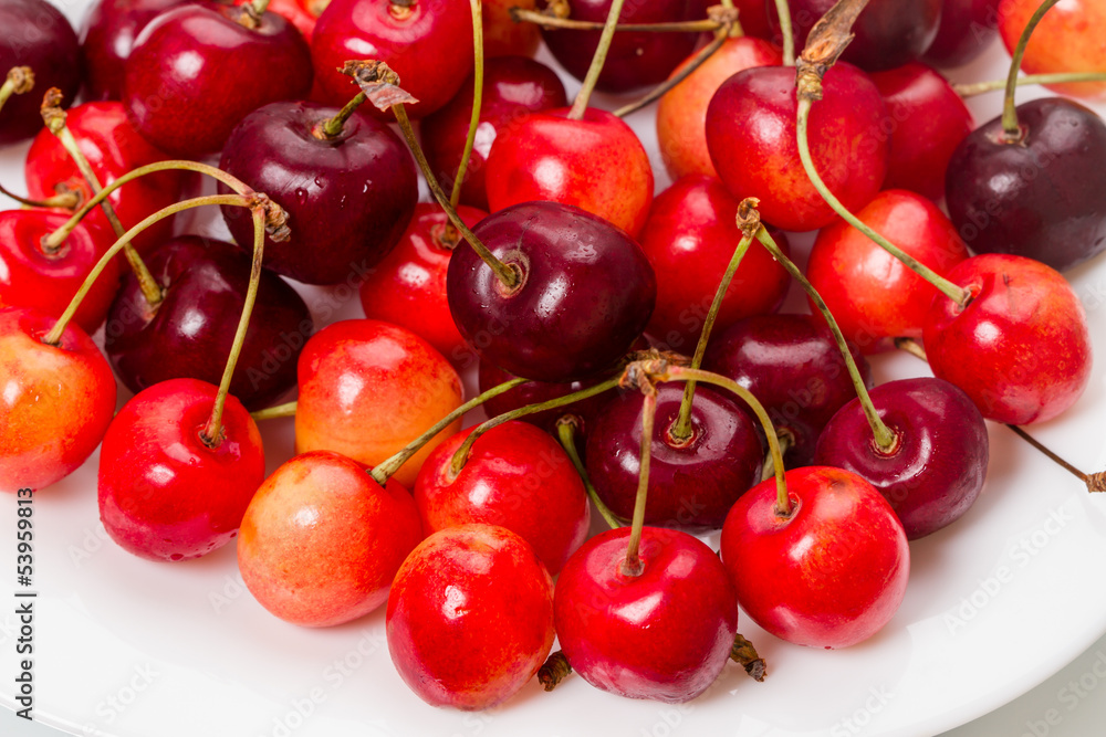 Ripe cherries on a white plate Ripe cherries on a white plate