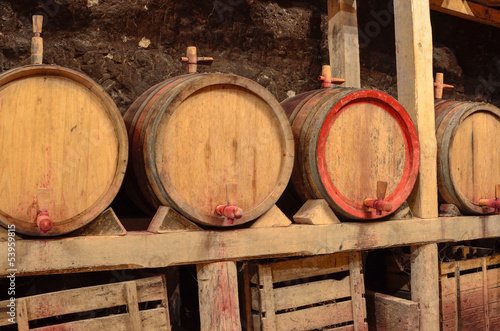 Wooden wine barrels in an underground cellar