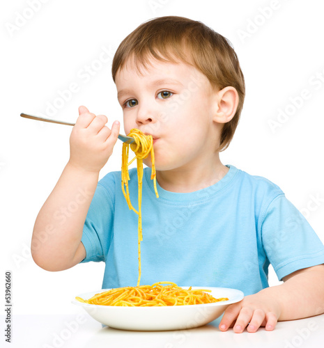 Little boy is eating spaghetti