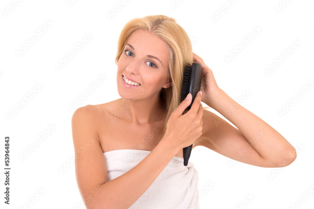 young attractive woman brushing her hair on white background young attractive woman brushing her hair on white background
