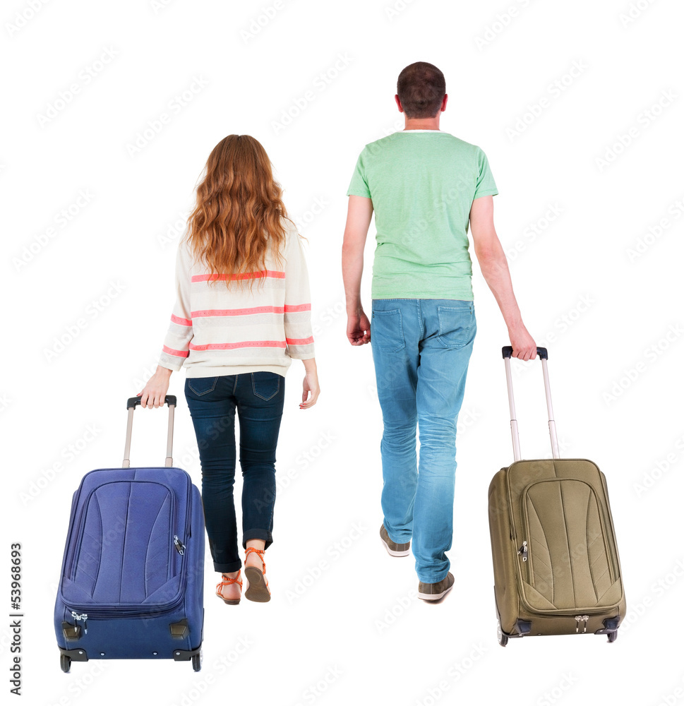 back view of walking couple with suitcase. back view of walking couple with suitcase.
