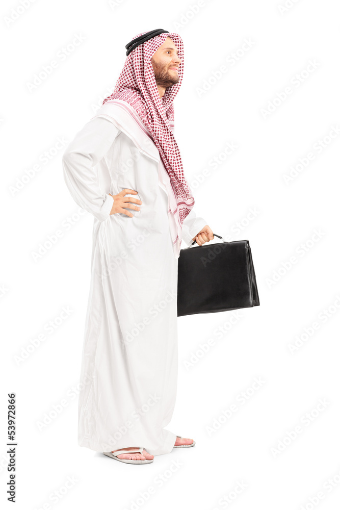 Full length portrait of a male arab person with suitcase posing